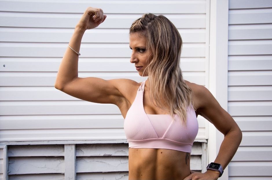 woman flexing arm muscles because of strong immune system